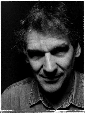 Black-and-white portrait of Peter Watts looking into the camera.