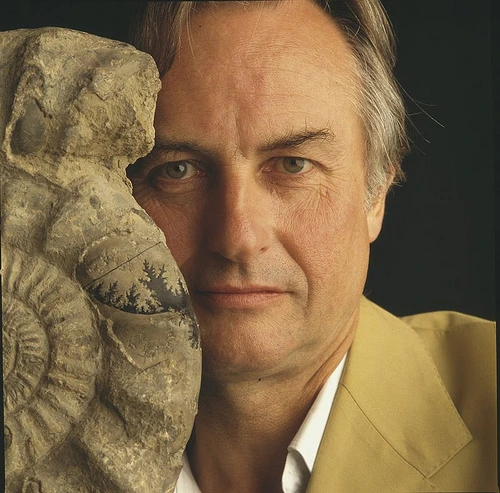 Richard Dawkins beside a close-up of a fossil