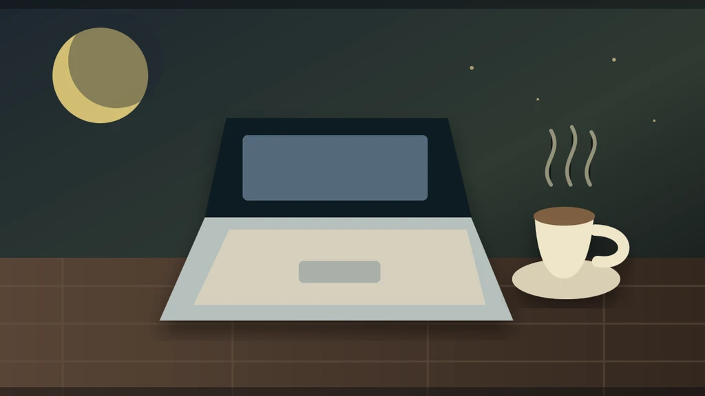 A laptop and a cup of tea on a kitchen table at night