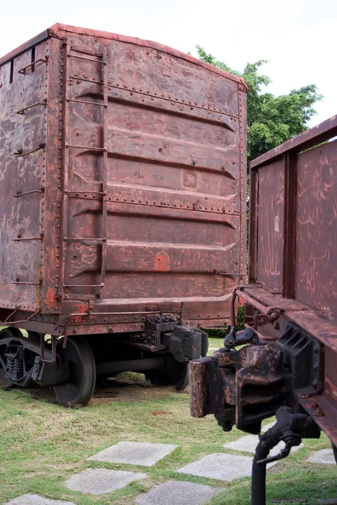 The red-brown carriages and couplings at the Tren Blindado monument in Santa Clara