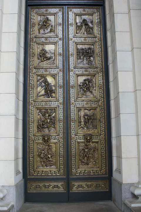 Tall Capitol doors covered with sculpted relief panels and geometric borders