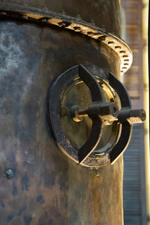 A circular hatch with heavy handles and bolts on a metal vessel at Havana Club