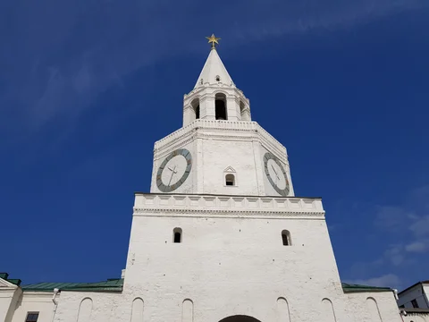 The white clock tower at the entrance to the Kazan Kremlin, seen from below.