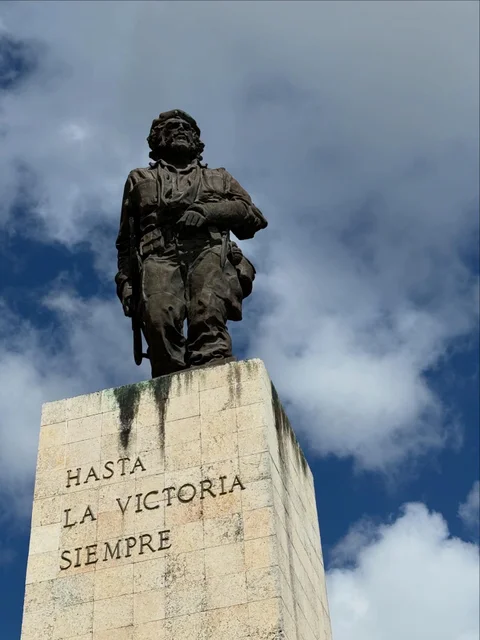 The bronze statue of Che Guevara above the words Hasta la Victoria Siempre at his memorial in Santa Clara