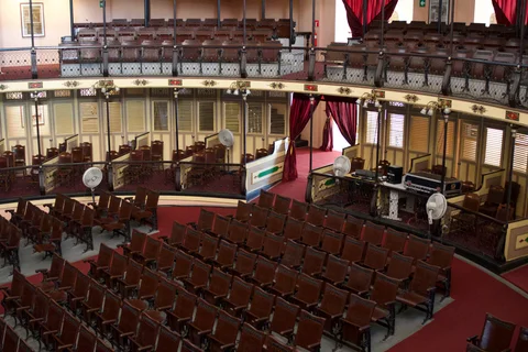The auditorium of Teatro Tomás Terry in Cienfuegos, with wooden seats, curved balconies and red curtains