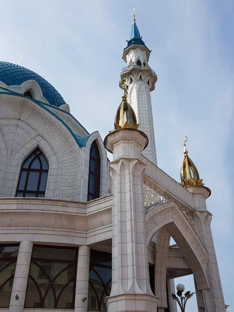 Pale stone arches and gold-coloured details at the entrance to Kul Sharif.