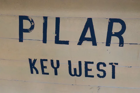 The painted name Pilar and the words Key West on the stern of Hemingway’s boat