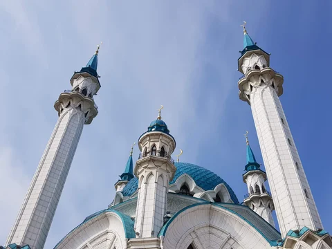 The white minarets and turquoise dome of the Kul Sharif Mosque, seen from below.