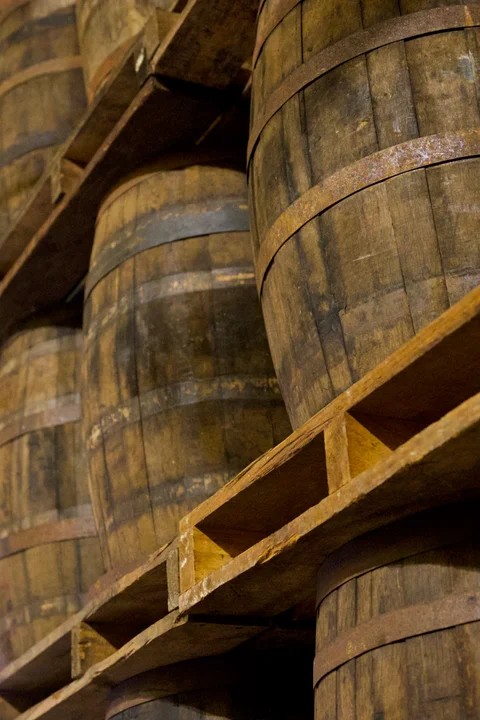 Wooden rum barrels stacked on shelves at Havana Club